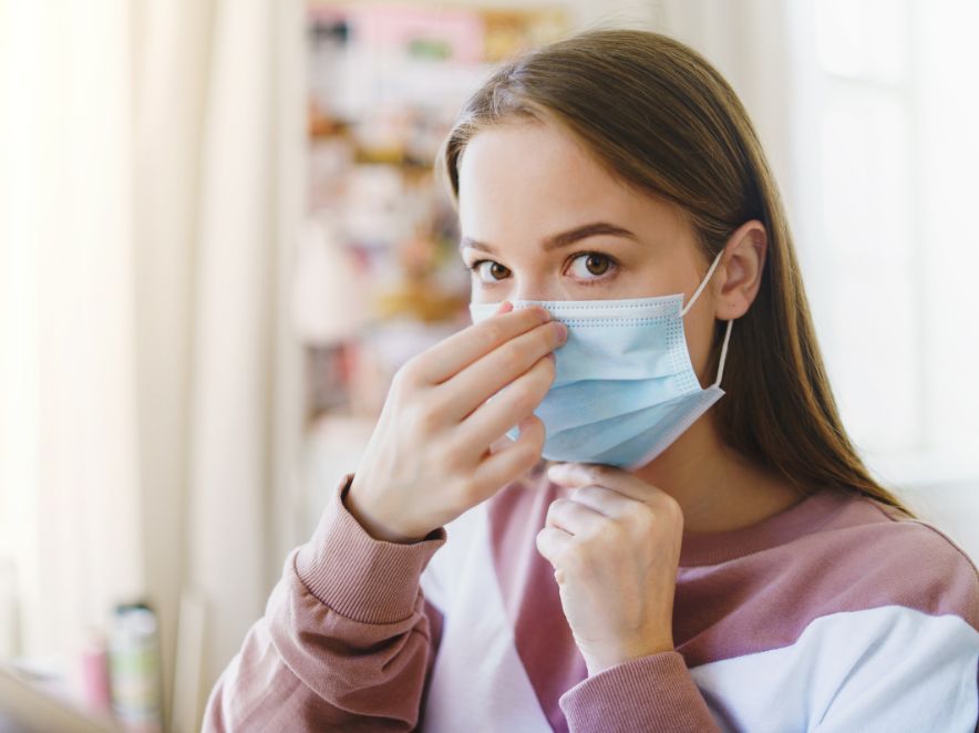 Patient wearing a face mask at home